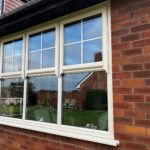 Cream PVC windows St Helens, georgian bar windows with sash horns, Green composite door with vertical pull handle