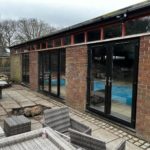 We recently completed a striking installation in Burscough, fitting a set of black PVCu French doors, matching windows and sidelights into a dedicated swimming pool room.
