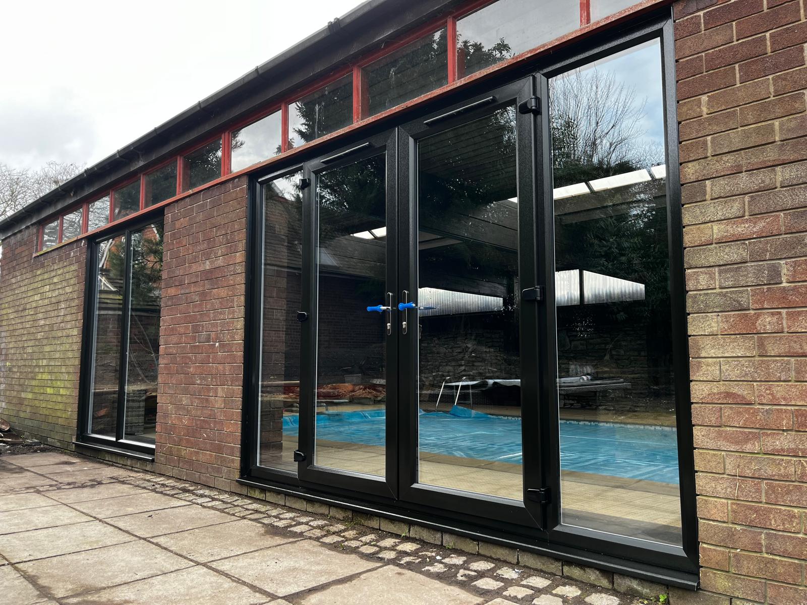 We recently completed a striking installation in Burscough, fitting a set of black PVCu French doors, matching windows and sidelights into a dedicated swimming pool room.