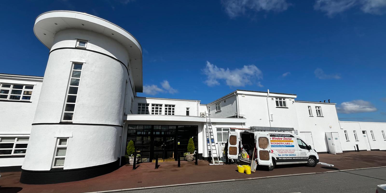 Royal Birkdale Golf Club window replacement and repairs. Windowcare Northwest vans are unloaded outside the Royal Birkdale club house as work to replace and repair PVC windows is carried out.