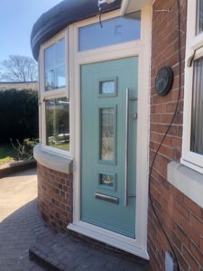 Cream PVC windows St Helens, georgian bar windows with sash horns, Green composite door with vertical pull handle
