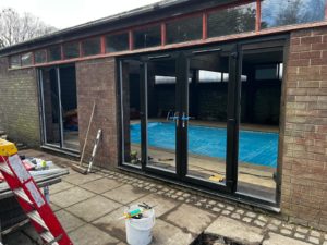 We recently completed a striking installation in Burscough, fitting a set of black PVCu French doors, matching windows and sidelights into a dedicated swimming pool room.