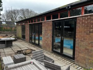 We recently completed a striking installation in Burscough, fitting a set of black PVCu French doors, matching windows and sidelights into a dedicated swimming pool room.