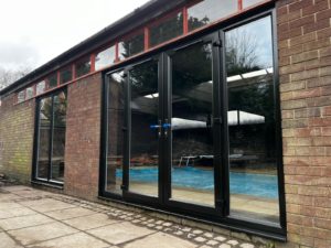 We recently completed a striking installation in Burscough, fitting a set of black PVCu French doors, matching windows and sidelights into a dedicated swimming pool room.