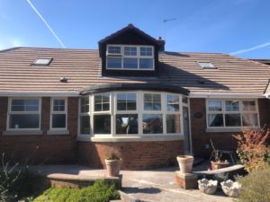 Cream PVC windows St Helens, georgian bar windows with sash horns, Green composite door with vertical pull handle